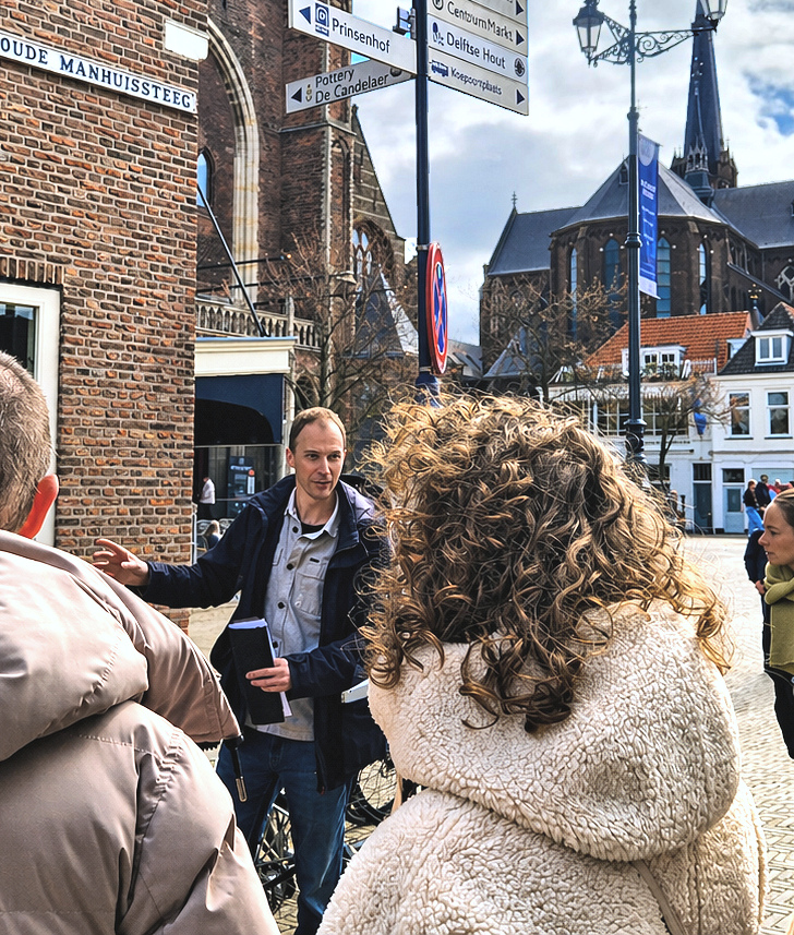 Your smiling guide against the backdrop of sunny Delft